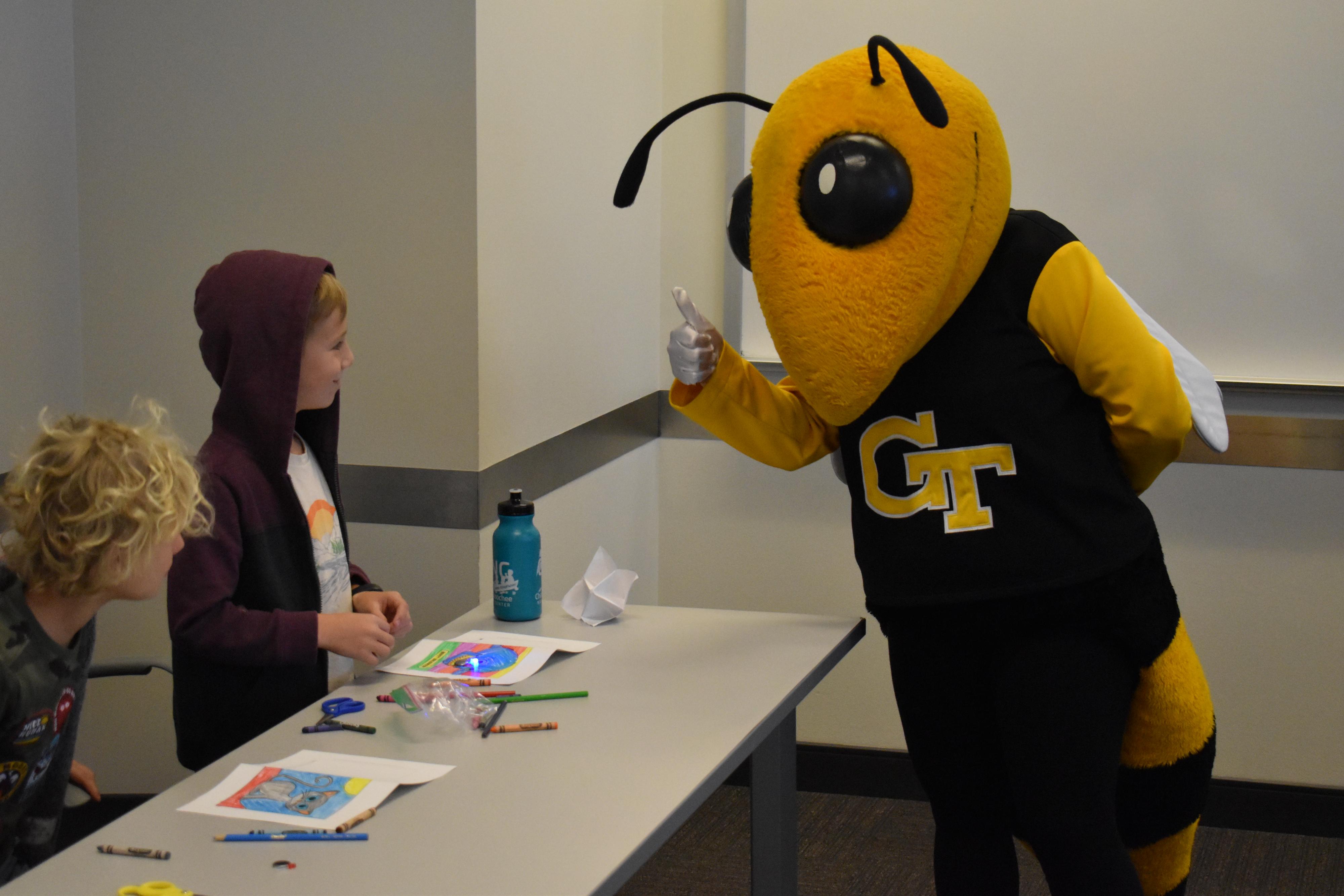 Buzz interacting with student.