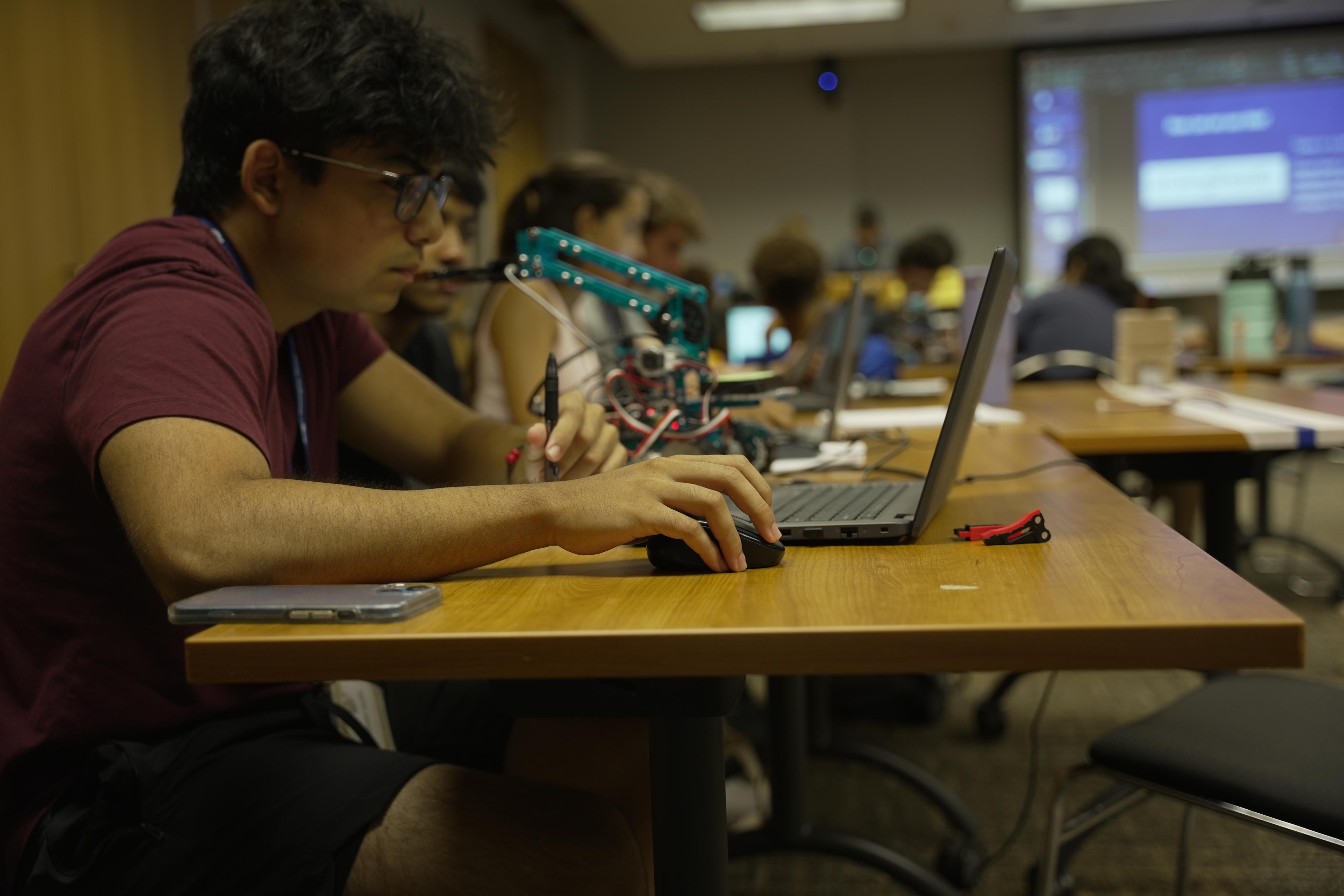 Student working intently in their computer.