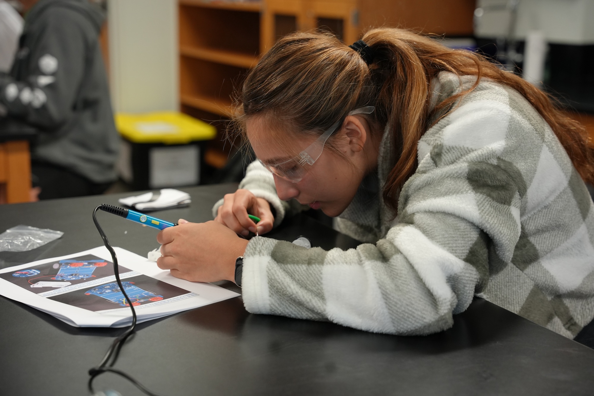 High school girl working on an engineering project.