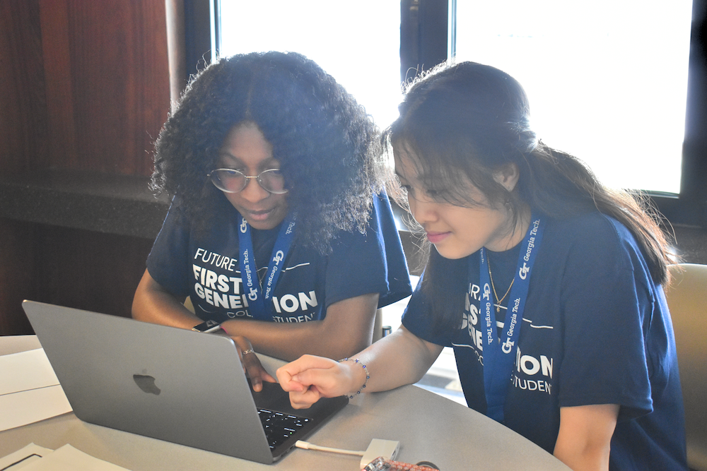 Students working on computer at First Generation College Institute